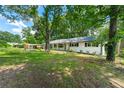 Well maintained yard and exterior of single story home with an attached carport at 4103 Laynewood Cir, Tucker, GA 30084