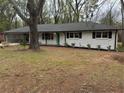 Charming single-story home with fresh exterior paint, mature trees, and a welcoming front yard at 4103 Laynewood, Tucker, GA 30084