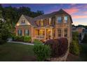 Beautiful two-story brick home with manicured landscaping, covered porch, and classic architectural details at sunset at 4388 Cades Pointe, Marietta, GA 30066