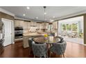 Bright kitchen featuring stainless steel appliances, granite countertops, a breakfast area, and access to the living room at 4388 Cades Pointe, Marietta, GA 30066