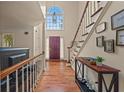Inviting foyer with hardwood floors, staircase, and front door with a large window above at 502 Fortune Ridge Rd, Stone Mountain, GA 30087