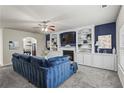 Cozy living room featuring a fireplace, built-in shelving, and a comfortable blue sofa at 47 Gloster Mill Way, Lawrenceville, GA 30044