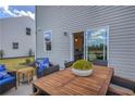 Outdoor patio area featuring a wooden table with chairs, cozy cushions, and view of the backyard at 508 Regency Trl, Acworth, GA 30102