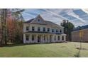 Stately two-story home with a lush green lawn and attractive architectural details at 76 Homesite Dulles Dr, Mcdonough, GA 30253