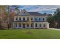 Charming two-story home with a well-manicured lawn and a welcoming front porch at 76 Homesite Dulles Dr, Mcdonough, GA 30253