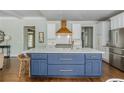 Gourmet kitchen featuring a large island with marble countertop and stainless steel appliances at 1100 Lady Slipper Way, Canton, GA 30115