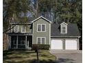 Two-story traditional home with a two-car garage and well-maintained landscaping at 1320 Country Acres Ln, Lawrenceville, GA 30045