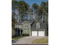 Two-story home featuring a two-car garage, traditional design, and a well-manicured lawn at 1320 Country Acres Ln, Lawrenceville, GA 30045