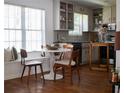 Eat-in kitchen featuring wood floors, white cabinets, and a cozy window seat at 1320 Country Acres Ln, Lawrenceville, GA 30045