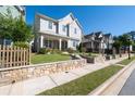 Inviting two-story home features a charming porch, stone retaining wall and well-kept landscaping at 2100 Drew Nw Dr, Atlanta, GA 30318