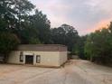 Commercial building featuring metal siding, and asphalt parking at 2526 Panola Rd, Lithonia, GA 30058