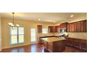 Spacious kitchen with stainless appliances, dark wood cabinets, granite counters, and a center island at 5010 Lynnonhall Ct, Stonecrest, GA 30038