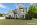 Charming two-story home with green siding, dark shutters and a well-manicured front yard at 700 Ridgeway Ct, Canton, GA 30114