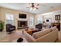 Comfortable living space with stone fireplace, ceiling fan, and open layout to dining area at 700 Ridgeway Ct, Canton, GA 30114