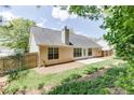 Spacious backyard with a wooden fence, offering privacy and room for outdoor activities at 2175 Charleston Oak Cir, Lawrenceville, GA 30043