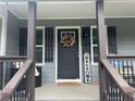 Close-up of a welcoming front door, enhanced by decorative accents at 2298 Hillbriar Dr, Buford, GA 30518