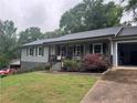Beautiful home featuring a well-maintained lawn with lush landscaping, charming front porch, and a cozy curb appeal at 2298 Hillbriar Dr, Buford, GA 30518