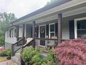 Inviting front porch with decorative accents and comfortable seating, perfect for relaxing at 2298 Hillbriar Dr, Buford, GA 30518