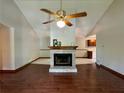 Inviting living room featuring a brick fireplace, wood floors, and vaulted ceilings at 3436 Finglas Dr, Marietta, GA 30008
