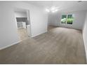 Spacious living area with new carpet, large windows, and modern lighting at 4504 Cedar Ridge Trl, Stone Mountain, GA 30083