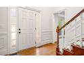 Bright foyer featuring hardwood floors, staircase, and detailed trim work, creating an inviting entrance at 720 Belgrave Ln, Tucker, GA 30084