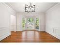 Elegant living room with hardwood floors, bay windows, and decorative molding, offering a refined space at 720 Belgrave Ln, Tucker, GA 30084