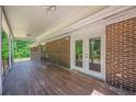 Covered brick patio with double doors leading inside, offering a seamless indoor-outdoor transition at 2133 Bird Ln, Snellville, GA 30078