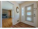 Inviting entryway featuring a light-filled doorway and wood floors, leading to a cozy living area with a fireplace at 2133 Bird Ln, Snellville, GA 30078