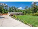 Charming one-story home with a well-maintained lawn, lush landscaping, and a spacious driveway at 2133 Bird Ln, Snellville, GA 30078