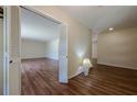 Hallway featuring wood floors, neutral paint, and white doors, creating a bright and open feel throughout the home at 2133 Bird Ln, Snellville, GA 30078