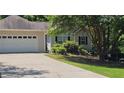 Charming home featuring an attached two car garage, traditional curb appeal, and a well-manicured lawn at 239 Clear Brook Trl, Douglasville, GA 30134