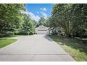 Beautiful single-story home featuring an attached garage, a long driveway, and mature trees at 239 Clear Brook Trl, Douglasville, GA 30134