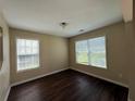 Bedroom featuring hardwood floors, natural light from a large window, and neutral colored walls at 4649 Camelot Dr, Douglasville, GA 30135