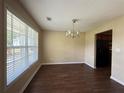 Dining room featuring hardwood floors, neutral colored walls, modern chandelier, and natural light at 4649 Camelot Dr, Douglasville, GA 30135