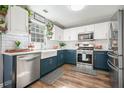 Modern kitchen featuring white subway tile backsplash, farmhouse sink, and stainless steel appliances at 537 Autumn Ridge Dr, Canton, GA 30115