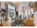 Formal dining room featuring hardwood floors, large windows, and elegant chandelier at 3018 Saint Andrews Ct, Jonesboro, GA 30236