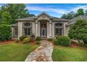 Charming home featuring a stone walkway leading to a beautiful front door and large windows at 3018 Saint Andrews Ct, Jonesboro, GA 30236