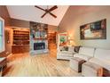 Spacious living room with hardwood floors, stone fireplace, vaulted ceilings, and built-in shelves at 507 Falls Way, Woodstock, GA 30188