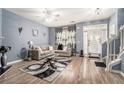 Inviting living room with stylish decor, modern furniture, wood floors, and ample natural light at 7244 Rockhouse Rd, Austell, GA 30168