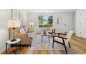 Cozy living room with hardwood floors, neutral paint, and stylish furniture at 1275 Muirforest Way, Stone Mountain, GA 30088