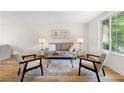 Comfortable living area featuring hardwood floors, neutral decor, and a large window for natural light at 1275 Muirforest Way, Stone Mountain, GA 30088