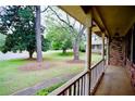 Inviting covered front porch with brick columns, offering a view of the lush front yard at 1838 Cates Ct, Snellville, GA 30078