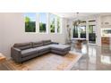 Open living room featuring a sectional couch, polished concrete floors, and sliding patio doors at 53 Daniel Se St, Atlanta, GA 30312