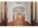 Grand entrance with hardwood floors, arched doorways, and elegant chandelier at 5816 Chamblee Dunwoody Rd, Atlanta, GA 30338