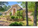 Brick home with well-maintained landscaping and prominent front entrance at 5816 Chamblee Dunwoody Rd, Atlanta, GA 30338