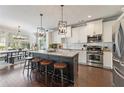 Modern kitchen featuring white cabinets, stainless steel appliances, and a granite-topped island with seating at 1338 Dupont Nw Park, Atlanta, GA 30318