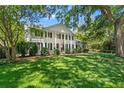 Colonial-style home with white exterior, black shutters, and a well-manicured front yard at 2580 Hyde Manor Dr, Atlanta, GA 30327