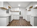 Bright kitchen featuring white cabinets, marble countertops, and hardwood flooring, perfect for modern living at 6032 Lakeshore Se Dr, Mableton, GA 30126