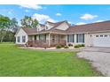 Charming home featuring a cozy front porch, an attached two-car garage and a well-manicured front lawn at 24 Fossetts Nw Cv, Cartersville, GA 30121