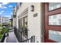 Close up of a townhome exterior featuring a brick facade and a private porch at 1030 Burnside Nw Pl, Atlanta, GA 30318